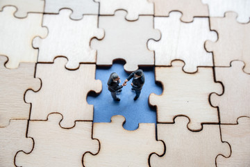 Fototapeta premium Miniature on wood jigsaw, Business concept