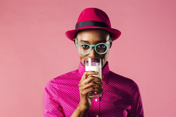 Woman taking a sip out of a glass of milk