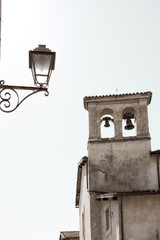 bell tower of an old church in an alley of Orvieto, Italy