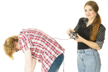Woman controling man using gaming pad
