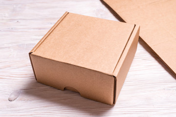 Small cardboard box on wooden desk