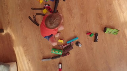 little boy is playing on the floor.