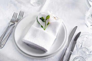 Plate at the table setting with glass on white