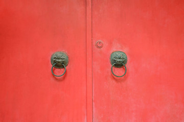Door handles on red door
