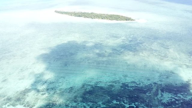 Aerial of Clouds Drifting Over Reef Flat and Tropical Island in Wakatobi