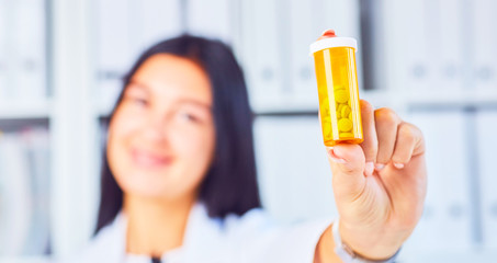 Woman doctor offers a jar of pills to the patientPanacea and life save, prescribe antidepressant, legal drug store, ward round, give or take potion, vitamin aid concept