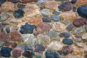 Stone masonry walls. Mountain colored natural stones. Natural stone
