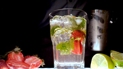 Lime, mint, strawberry, transparent glass, ice cubes.