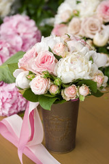 Brides bouquet with peony roses and ribbon.