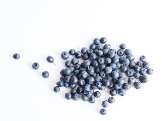 Fresh forest blueberries on a white background close up, soft focus. Summer wild berry

