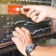 Audio mixer sound and hands of sound engineer working on studio mixer.