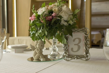 Beautiful flower bouquet on decorated wedding table.