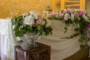 Wedding table decoration with glases flowers bouqet.