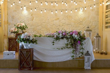 Wedding table decoration with glases flowers bouqet.