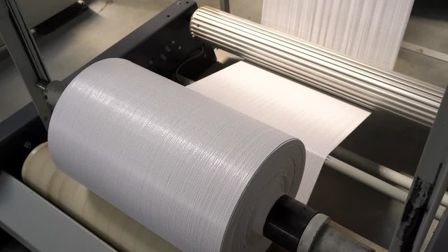 The resulting polypropylene sleeve for the manufacture of bags is wound on large reels. drum for winding sleeves of woven polypropylene yarns. PP bag production line