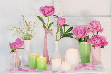 Fototapeta na wymiar flowers in vases and candles on white background