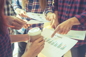 Casual business team is discussing report in meeting, no face