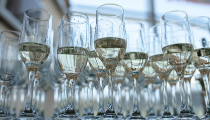 View from below of half full champagne or bubbly flutes, a typical wedding reception or party welcome for the guests