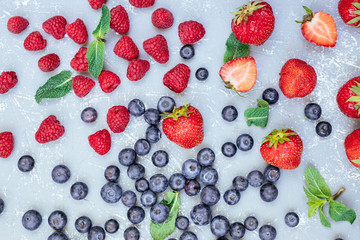 Mix of fresh juicy berries on blue background, top view