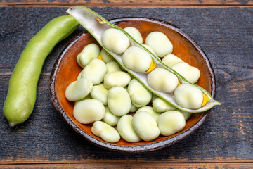 New harvest of healthy vegetables, green fresh raw big broad beans close up