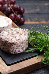 French soft cheeses, variety of different taste goat milk natural cheeses on granite plate close up sesrved as dessert