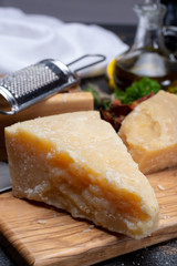 Traditional italian food - 36 months aged in caves Italian parmesan hard cheese from Parmigiano-Reggiano, Italy