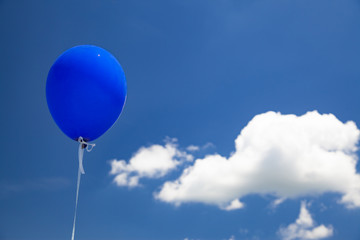 Blue baloon flying in the sky