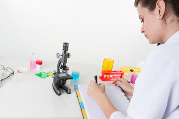 pretty female health care professional in his working environment laboratory