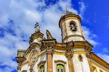 Fototapeta na wymiar Old catholic tower church facade of the 18th century view from below and located in the center of the famous and historical city of Ouro Preto in Minas Gerais