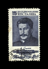Joseph Stalin, famous soviet politician leader, 75th birth anniversary, circa 1954.. vintage canceled postal stamp printed in USSR (Soviet Union) isolated on black background.