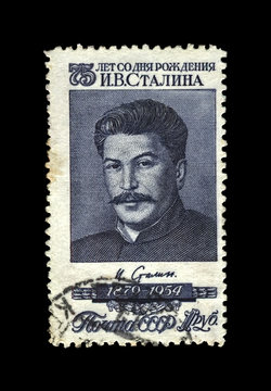 Joseph Stalin, famous soviet politician leader, 75th birth anniversary, circa 1954.. vintage canceled postal stamp printed in USSR (Soviet Union) isolated on black background.