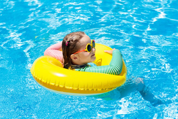 Child in swimming pool. Kids swim. Water play.