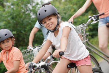 Naklejka premium Portrait of 7-year-old girl riding bike