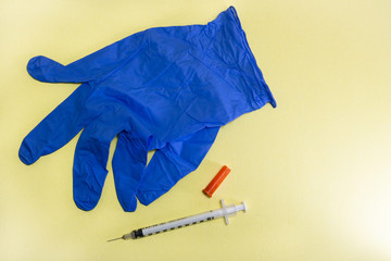 Blue Latex Glove and Hypodermic Needle