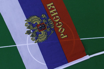 Russia flag on green field in stadium. Football background with russian flag- 2018
