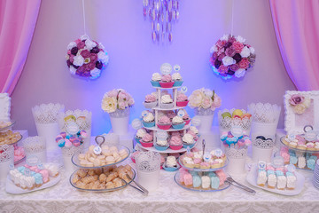 Delicious dessert bar at a wedding, party or event, exhibiting different tiered cake stands, filled...