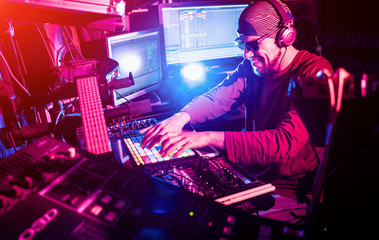 Sound engineer working at mixing panel in the in sound recording studio.