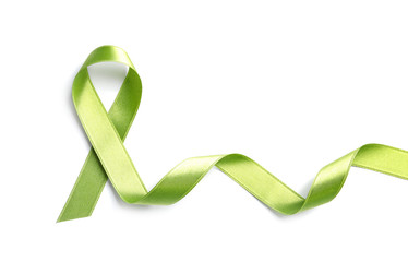 Green ribbon on white background, top view. Cancer awareness