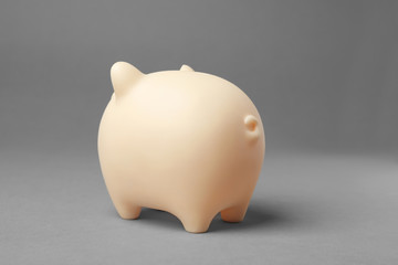 Cute piggy bank on gray background