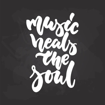 Music heals the soul - hand drawn Musical lettering phrase isolated on the black chalkboard background. Fun brush chalk vector quote for banners, poster design, photo overlays.