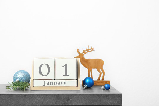 Wooden block calendar and festive decor on table. Christmas countdown