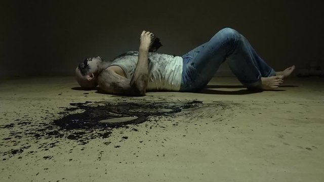 Laying man vomiting black goo