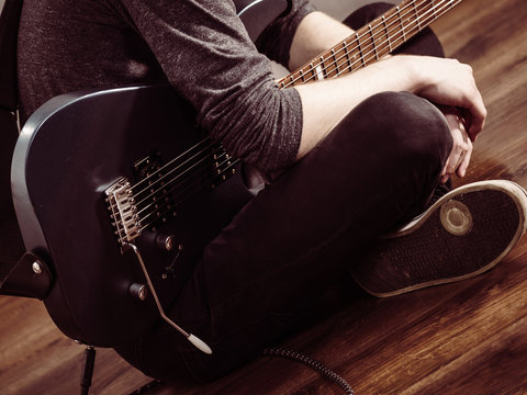 Male hands playing electric guitar