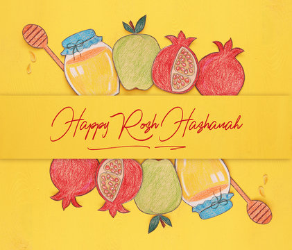 Rosh hashanah (jewish New Year holiday) concept. Traditional symbols shapes cut from paper and painted.
