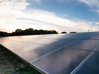 solar power, photovoltaic power plant and blue sky with clouds in the city.