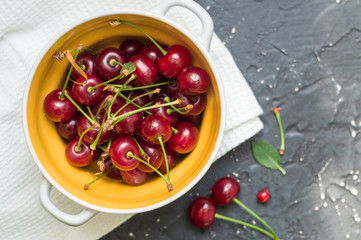 Cherries in a ceramic bowl on a dark background