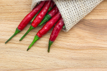 Close-up top view of red chili pepper on wood background