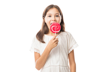 Beautiful cute little girl eating lollipop