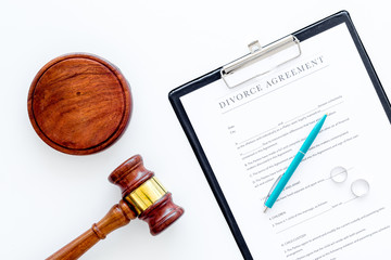 Divorce court case. Divorce agreement near wedding rings and judge gavel on white background top...