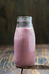 blueberries milkshake in a bottle, vertical